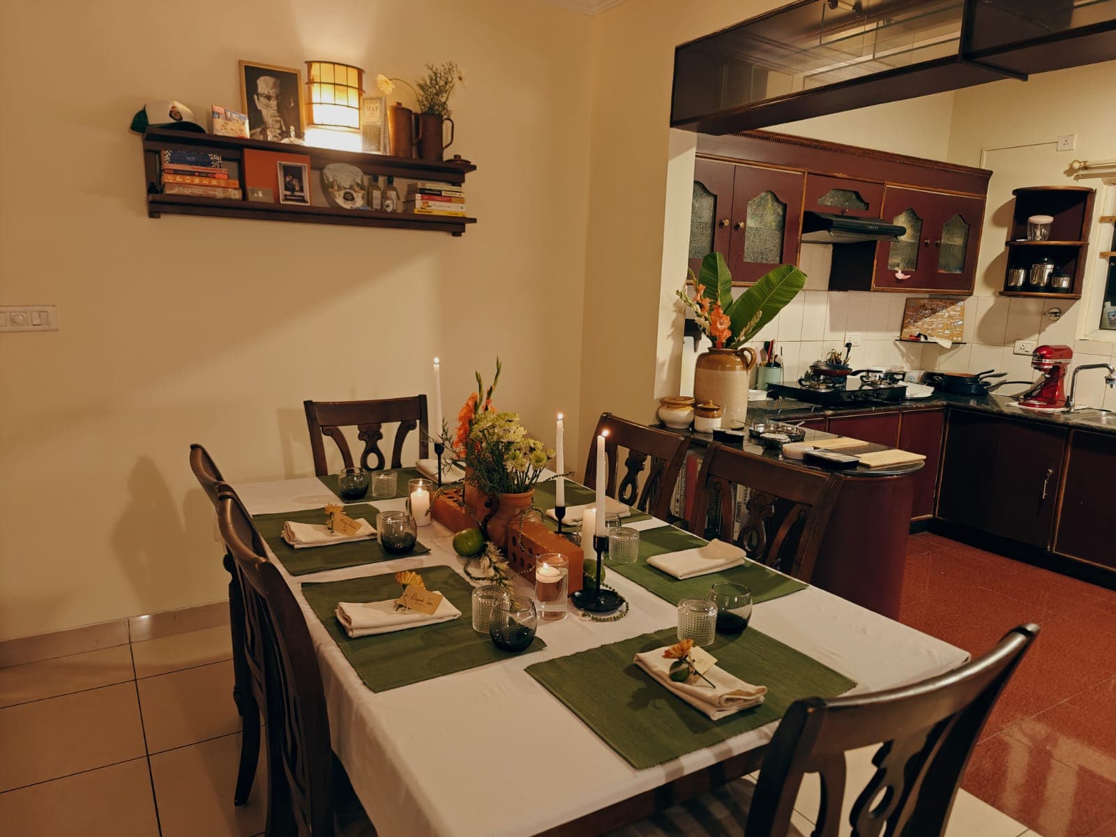 The dinner table set for six, with candles and flowers, before anyone arrives